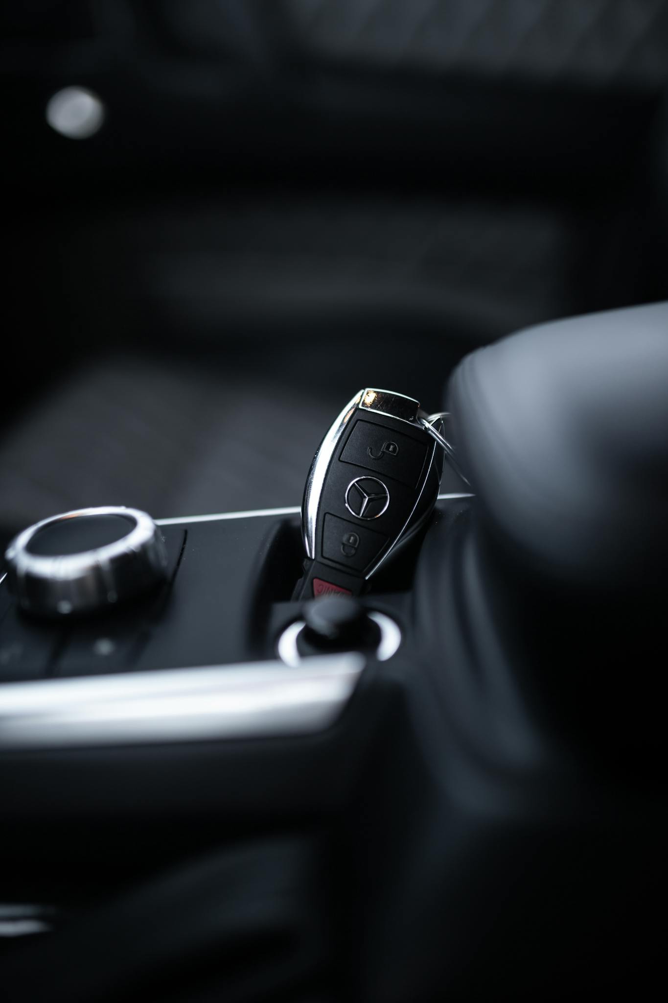 Close-up of a car key in the ignition of a luxury vehicle showing the modern interior and design.